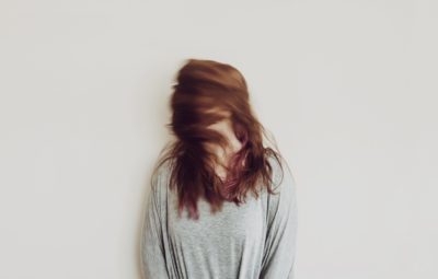 a person with long hair in her face